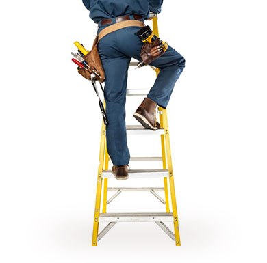 Construction worker climbing yellow ladder.